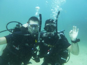 Stef and Seb scuba diving OK pose