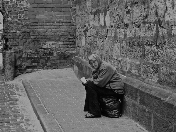 Old lady begging in Riga's Old Town
