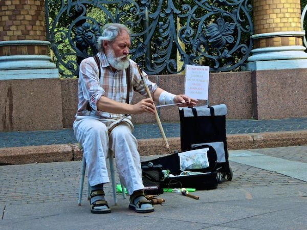 Man playing saw with violin bow